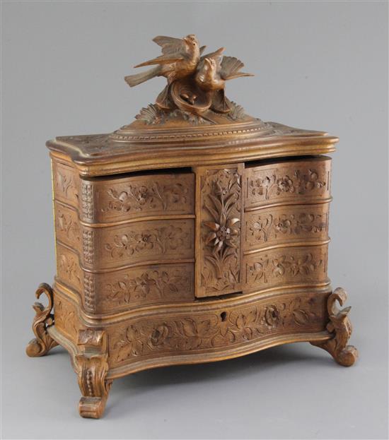 A late 19th century Black Forest carved wood jewellery casket, width 11.5in. height 12.5in.